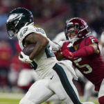 
              Philadelphia Eagles running back Miles Sanders (26) escapes the grasp of Houston Texans safety Jalen Pitre (5) in the first half of an NFL football game in Houston, Thursday, Nov. 3, 2022. (AP Photo/Tony Gutierrez)
            