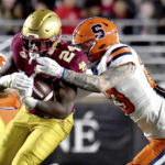 
              Syracuse's Justin Barron closes in on Boston College running back Pat Garwo for a tackle during the first half of an NCAA college football game Saturday, Nov. 26, 2022, in Boston. (AP Photo/Mark Stockwell)
            