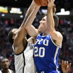 
              BYU guard Spencer Johnson (20) shoots over San Diego State guard Matt Bradley (20) during the second half of an NCAA college basketball game Friday, Nov. 11, 2022, in San Diego. (AP Photo/Denis Poroy)
            