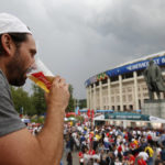 
              FILE - In this July 11, 2018 photo, a man drinks a beer in a Budweiser pavilion in front of the Lenin statue and the Luzhniki Stadium as fans arrive for the semifinal match between Croatia and England, during the 2018 soccer World Cup in Moscow, Russia. The sale of all beer with alcohol at the eight World Cup stadiums in Qatar has been banned. The decision comes only two days before the soccer tournament is set to start. Non-alcoholic beer will still be available for fans at the 64 matches. FIFA says the decision was made "following discussions between host country authorities and FIFA." (AP Photo/Rebecca Blackwell, File)
            