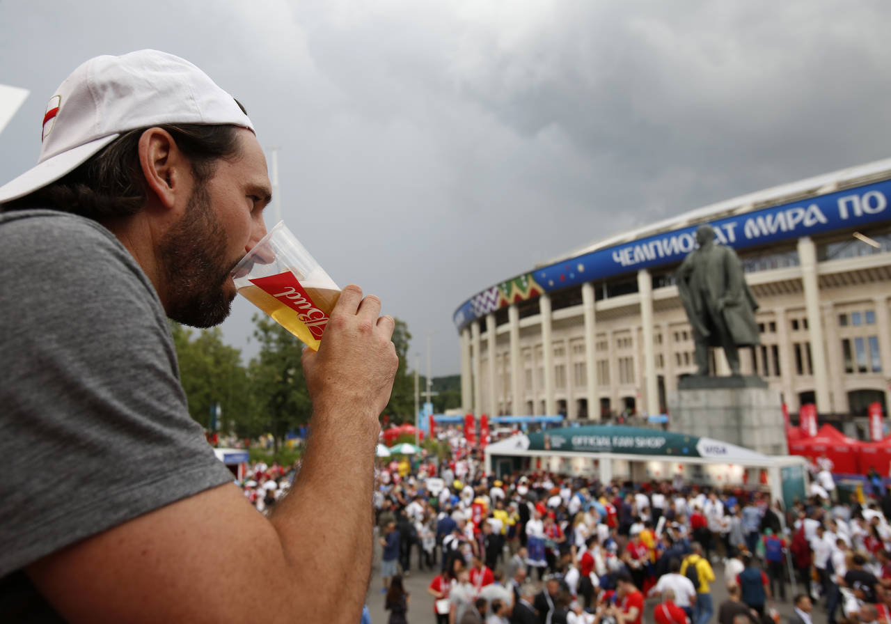 FILE - In this July 11, 2018 photo, a man drinks a beer in a Budweiser pavilion in front of the Len...