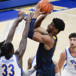 
              West Virginia's Mohamed Wague, second from right,shoots over Pittsburgh's Federiko Federiko (33) during the second half of an NCAA college basketball game, Friday, Nov. 11, 2022, in Pittsburgh. (AP Photo/Keith Srakocic)
            