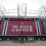 
              FILE - Security and stewards stand outside the Old Trafford stadium in Manchester, England, Tuesday, May 11, 2021 ahead of the English Premier League soccer match between Manchester United and Leicester City. Manchester United's American owners confirmed Tuesday, Nov. 22, 2022,  they would consider putting the iconic Premier League club up for sale. United said the Glazer family was exploring outside funding to enhance growth — a move that could pave the way to a potential buyout. (AP Photo/Jon Super, FIle)
            