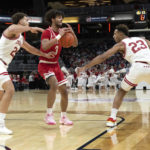 
              Miami (Ohio) guard Bryson Tatum (4) loses control of the ball between Indiana forwards Race Thompson (25) and Trayce Jackson-Davis (23) during the first half of an NCAA college basketball game, Sunday, Nov. 20, 2022, in Indianapolis. (AP Photo/Marc Lebryk)
            