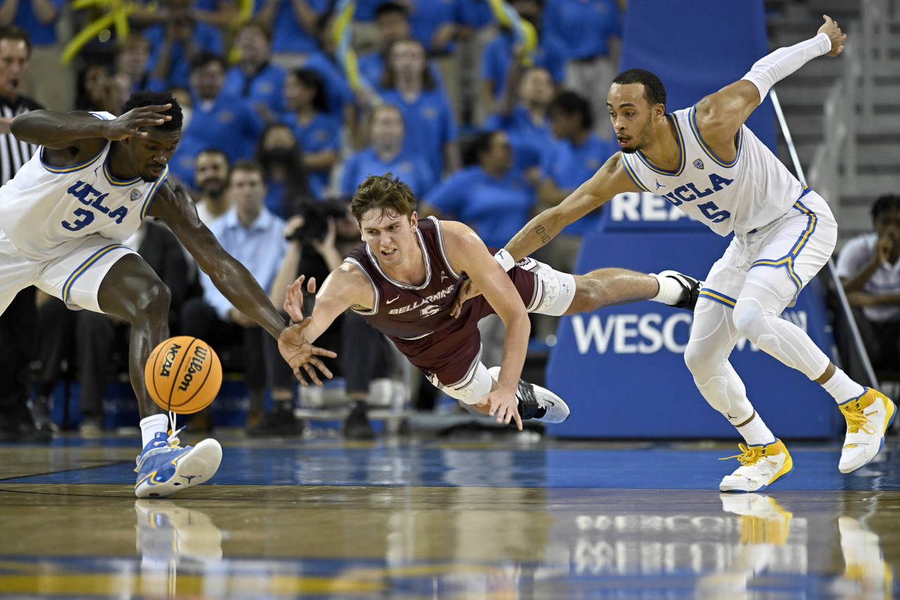 UCLA forward Adem Bona, left, vies for a loose ball with guard Amari Bailey, right, against Bellarm...