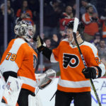 
              Philadelphia Flyers' Carter Hart, left, and Nick Seeler celebrate after an NHL hockey game against the New York Islanders, Tuesday, Nov. 29, 2022, in Philadelphia. (AP Photo/Matt Slocum)
            