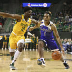 
              McNeese State guard Trae English drives to the basket over Baylor guard Adam Flagler (10) in the first half of an NCAA college basketball game, Wednesday, Nov. 23, 2022, in Waco, Texas. (AP Photo/Rod Aydelotte)
            