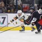 
              Vegas Golden Knights' William Carrier, left, and Columbus Blue Jackets' Marcus Bjork chase a loose puck during the third period of an NHL hockey game on Monday, Nov. 28, 2022, in Columbus, Ohio. (AP Photo/Jay LaPrete)
            