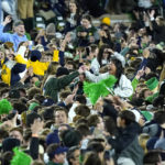
              Notre Dame fans storm the field after the Fighting Irish defeated Clemson 35-14 in an NCAA college football game Saturday, Nov. 5, 2022, in South Bend, Ind. (AP Photo/Charles Rex Arbogast)
            