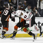 
              Chicago Blackhawks center Colin Blackwell, center, leaps into Anaheim Ducks center Trevor Zegras (11) with Ducks right wing Troy Terry, left, looking on during the first period of an NHL hockey game in Anaheim, Calif., Saturday, Nov. 12, 2022. (AP Photo/Alex Gallardo)
            