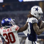 
              Dallas Cowboys wide receiver CeeDee Lamb (88) catches a pass for a first down as New York Giants cornerback Darnay Holmes (30) defends during the second half of an NFL football game Thursday, Nov. 24, 2022, in Arlington, Texas. (AP Photo/Ron Jenkins)
            