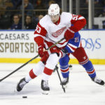 
              Detroit Red Wings defenseman Moritz Seider (53) skates with the puck in front of New York Rangers center Barclay Goodrow during the second period of an NHL hockey game Sunday, Nov. 6, 2022, in New York. (AP Photo/John Munson)
            