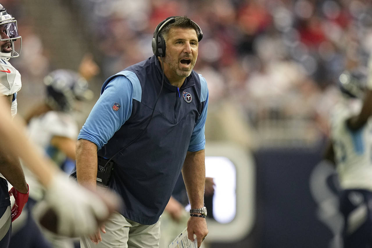Tennessee Titans head coach Mike Vrabel yells to his players during the first half of an NFL footba...
