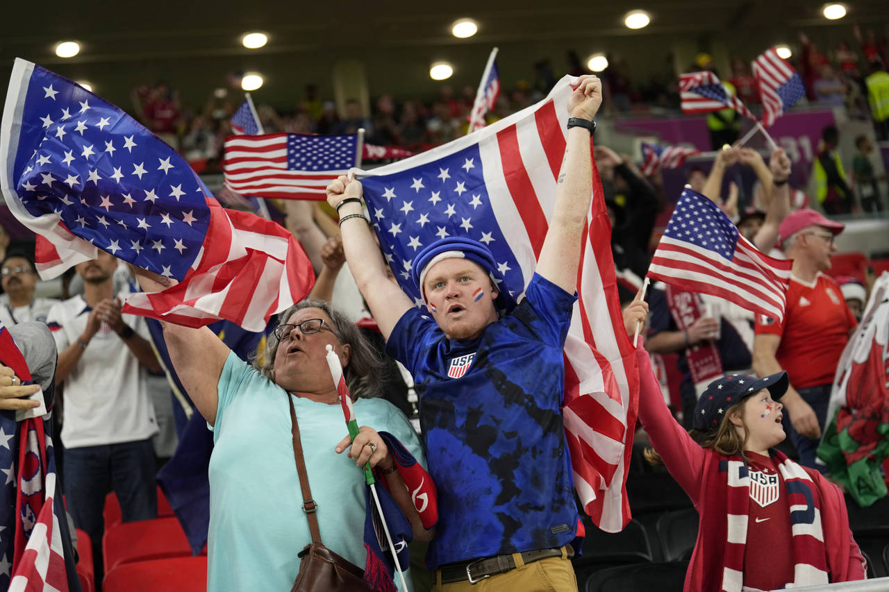 USA supporters cheer at the end of the World Cup, group B soccer match between the United States an...