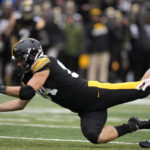 
              Iowa tight end Sam LaPorta (84) looks to catch a pass ahead of Wisconsin cornerback Alexander Smith, right, during the first half of an NCAA college football game, Saturday, Nov. 12, 2022, in Iowa City, Iowa. The pass was incomplete. (AP Photo/Charlie Neibergall)
            