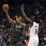 
              Minnesota Timberwolves center Karl-Anthony Towns (32) passes the ball away from Houston Rockets forward Usman Garuba (16) during the first half of an NBA basketball game Saturday, Nov. 5, 2022, in Minneapolis. (AP Photo/Stacy Bengs)
            