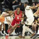 
              Georgia guard Terry Roberts (0) moves around the defense of Wake Forest guard Daivien Williamson (4) in the first half of an NCAA college basketball game Friday, Nov. 11, 2022, in Winston-Salem, N.C. (Allison Lee Isley/The Winston-Salem Journal via AP)
            