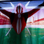 
              FILE - A fan of Kenya holds up a national flag during the final in the women's 5000-meter run at the World Athletics Championships on July 23, 2022, in Eugene, Ore. World Athletics President Seb Coe said Wednesday, Nov. 30, 2022 that reports about a possible full-scale ban for Kenya due to a protracted doping crisis were misguided, and that increased funding and vigilance from the Kenyan government persuaded authorities to stop short of the most radical sanctions. (AP Photo/Gregory Bull, File)
            