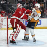 
              Nashville Predators left wing Tanner Jeannot (84) collides with Detroit Red Wings goaltender Ville Husso (35) in the first period of an NHL hockey game Wednesday, Nov. 23, 2022, in Detroit. (AP Photo/Paul Sancya)
            