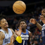 
              Memphis Grizzlies guard Ja Morant (12), Minnesota Timberwolves center Naz Reid (11) and guard Anthony Edwards (1) watch a loose ball in the first quarter of an NBA basketball game Wednesday, Nov. 30, 2022, in Minneapolis. (AP Photo/Andy Clayton-King)
            