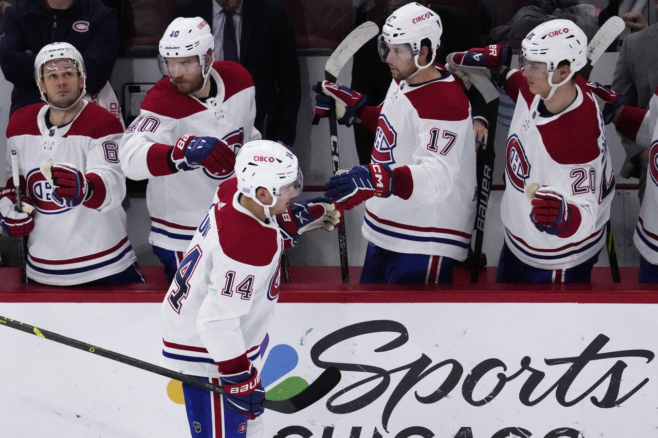 Montreal Canadiens center Nick Suzuki (14) celebrates with teammates after scoring his goal during ...
