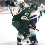 
              Minnesota Wild center Marco Rossi (23) and Seattle Kraken center Alex Wennberg (21) vie for the puck during the first period of an NHL hockey game Thursday, Nov. 3, 2022, in St. Paul, Minn. (AP Photo/Abbie Parr)
            