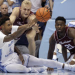 
              NNorth Carolina forward Leaky Black (1) passes the ball out after gaining control during a scramble with College of Charleston guard Dalton Bolon (3), top, and guard Jaylon Scott (21) during the first half of an NCAA college basketball game Friday, Nov. 11, 2022, in Chapel Hill, N.C. (AP Photo/Chris Seward)
            