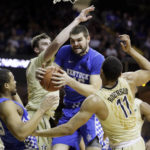 
              FILE - Kentucky forward Isaac Humphries, center, grabs a rebound in front of Vanderbilt's Luke Kornet, second from left, and Jeff Roberson (11) during the first half of an NCAA college basketball game on Jan. 10, 2017, in Nashville, Tenn. Melbourne United starting center Isaac Humphries has announced that he is gay and said he hopes his decision to publicly announce his sexuality will lead to more professional sportsmen doing the same. (AP Photo/Mark Humphrey, File)
            