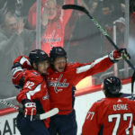 
              Washington Capitals left wing Sonny Milano (15) celebrates his goal with center Evgeny Kuznetsov (92) and right wing T.J. Oshie (77) during the third period of an NHL hockey game against the Philadelphia Flyers, Wednesday, Nov. 23, 2022, in Washington. The Capitals won 3-2 in overtime. (AP Photo/Nick Wass)
            