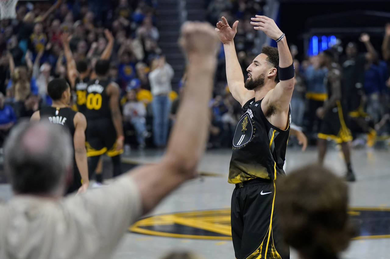 Golden State Warriors guard Klay Thompson gestures to fans after scoring against the Los Angeles Cl...