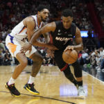 
              Miami Heat guard Kyle Lowry (7) dribbles around Phoenix Suns guard Cameron Payne (15) during the first half of an NBA basketball game Monday, Nov. 14, 2022, in Miami. (AP Photo/Marta Lavandier)
            