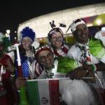 
              Iranian and US supporters pose for a photo before the World Cup group B soccer match between Iran and the United States at the Al Thumama Stadium in Doha, Qatar, Tuesday, Nov. 29, 2022. (AP Photo/Christophe Ena)
            