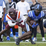 
              Duke's Jalon Calhoun (5) carries the ball ahead of Virginia Tech's Chamarri Conner (1) after completing a catch during the first half of an NCAA college football game in Durham, N.C., Saturday, Nov. 12, 2022. (AP Photo/Ben McKeown)
            