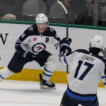 
              Winnipeg Jets' Josh Morrissey (44) celebrates scoring a goal with teammate Adam Lowry (17) during overtime in an NHL hockey game against the Dallas Stars in Dallas, Friday, Nov. 25, 2022. The Jets won 5-4. (AP Photo/LM Otero)
            