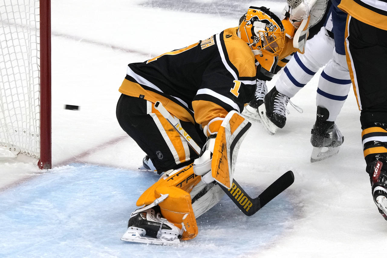 A shot by Toronto Maple Leafs' John Tavares gets past Pittsburgh Penguins goaltender Casey DeSmith ...