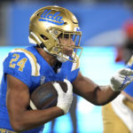 
              UCLA running back Zach Charbonnet runs the ball during the first half of an NCAA college football game against Arizona Saturday, Nov. 12, 2022, in Pasadena, Calif. (AP Photo/Mark J. Terrill)
            
