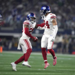 
              New York Giants safety Julian Love (20) celebrates with Dane Belton (24) after intercepting a pass against the Dallas Cowboys during the first half of an NFL football game Thursday, Nov. 24, 2022, in Arlington, Texas. (AP Photo/Tony Gutierrez)
            