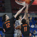 
              Xavier forward Zach Freemantle, center, has a shot blocked as Florida forward Colin Castleton, left, and guard Kyle Lofton defend during the first half of an NCAA college basketball game in the Phil Knight Legacy tournament in Portland, Ore., Thursday, Nov. 24, 2022. (AP Photo/Craig Mitchelldyer)
            