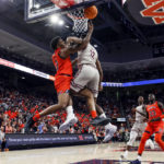 
              Auburn guard K.D. Johnson (0) if fouled by Texas Southern guard Zytarious Mortle (12) as he shoots during the second half of an NCAA college basketball game Friday, Nov. 18, 2022, in Auburn, Ala. (AP Photo/Butch Dill)
            