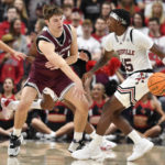 
              Louisville guard Hercy Miller (15) attempts to get past Bellarmine guard Peter Suder (5) during the first half of an NCAA college basketball game in Louisville, Ky., Wednesday, Nov. 9, 2022. (AP Photo/Timothy D. Easley)
            