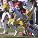 
              LSU running back Josh Williams (27) is tackled by Arkansas linebacker Bumper Pool (10) during the first half of an NCAA college football game Saturday, Nov. 12, 2022, in Fayetteville, Ark. (AP Photo/Michael Woods)
            