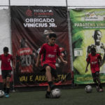 
              Boys play football at the Flamengo Sao Gonçalo school where Brazilian player Vinicius Jr., who was selected to compete in the 2022 Qatar World Cup, trained early in his career, in Sao Goncalo, Rio de Janeiro state, Brazil, Monday, Nov. 7, 2022. Four years ago teenager Vinicius Jr. took his first medal from a professional soccer tournament home, a place where drug gangs and vigilantes fight for control and children dribble past garbage on the streets. (AP Photo/Bruna Prado)
            