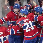 
              Players from the Montreal Canadiens celebrate a goal by teammate Mike Hoffman against the Pittsburgh Penguins during overtime period of an NHL hockey action in Montreal, Saturday, Nov. 12, 2022. (Graham Hughes/The Canadian Press via AP)
            