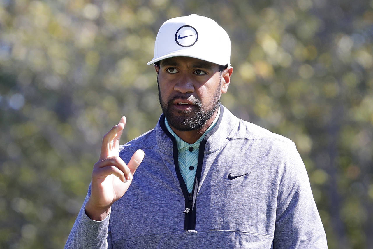 Tony Finau waves to the gallery as they cheer his birdie on the ninth hole during the final round o...