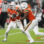 
              Miami quarterback Jake Garcia, left, hands off to running back Henry Parrish Jr. during the first half of an NCAA college football game against Pittsburgh, Saturday, Nov. 26, 2022, in Miami Gardens, Fla. (AP Photo/Lynne Sladky)
            