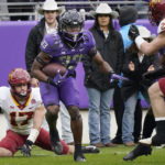 
              TCU running back Kendre Miller beats Iowa State defenders Beau Freyler (17) and Will McLaughlin on his way to score a touchdown during the first half of an NCAA college football game in Fort Worth, Texas, Saturday, Nov. 26, 2022. (AP Photo/LM Otero)
            