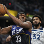 
              Indiana Pacers center Myles Turner (33) pulls in a rebound in front of Minnesota Timberwolves center Karl-Anthony Towns (32) during the first half of an NBA basketball game in Indianapolis, Wednesday, Nov. 23, 2022. (AP Photo/AJ Mast)
            