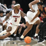 
              Louisville guard El Ellis (3) drives around Maryland guard Ian Martinez during the second half of an NCAA college basketball game in Louisville, Ky., Tuesday, Nov. 29, 2022. Maryland won 79-54. (AP Photo/Timothy D. Easley)
            