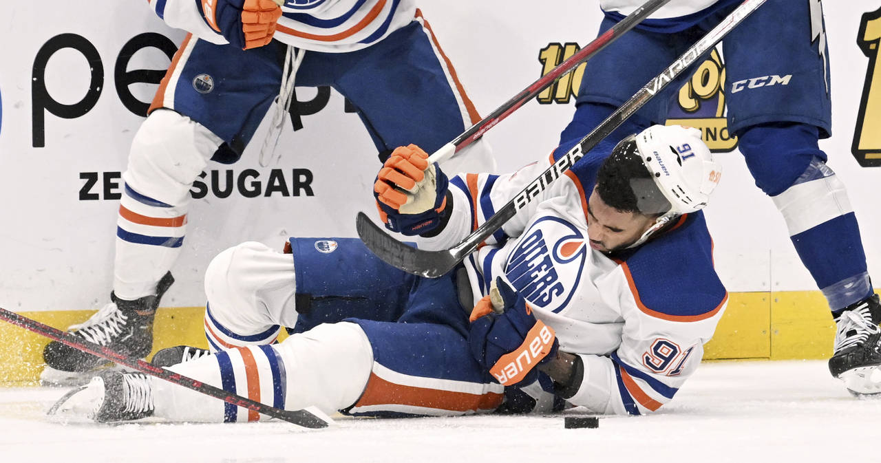 Edmonton Oilers left wing Evander Kane (91) is knocked to the ice during the second period of an NH...