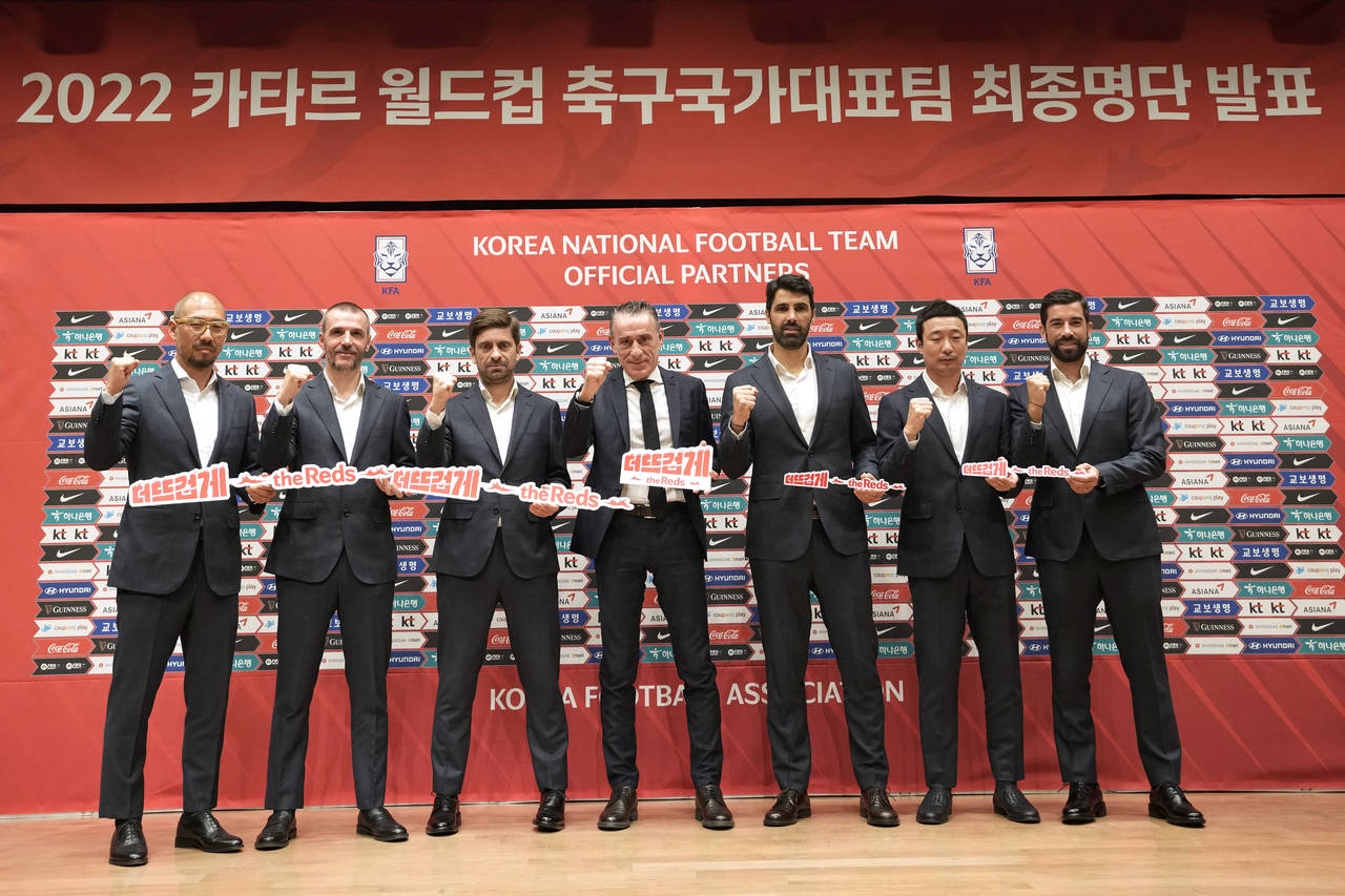 South Korean national soccer team head coach Paulo Bento, center, poses with his staff members afte...